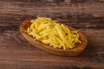Shredded yellow cheese in the bowl