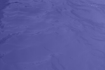 blue water wave texture background. Rippled water. Shiny purple and blue water surface.