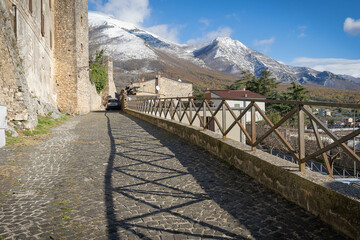 Obraz premium Beautiful landscape with snow-capped mountains and shadow from fence in Vico nel Lazio in province of Fronzinone, Italy