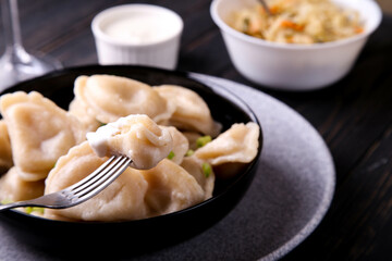 Dumplings with potatoes and sour cream. Vareniki is a dish of Slavic cuisine.