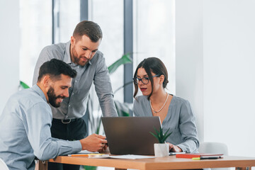 Winter daytime. Group of business people that working on the project in the office