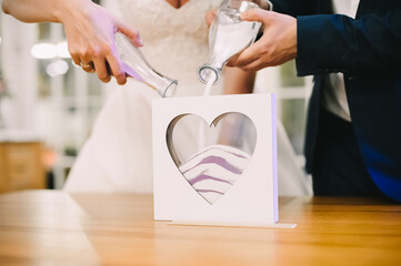 sand ceremony, newlyweds mix colorful sand