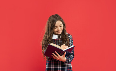 back to school. childhood education. making notes. smiling pupil or student hold notebook.