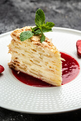 Layered baked pie with creamy vanilla swith cream, apples and strawberry jam decorated mint. vertical image. top view. place for text