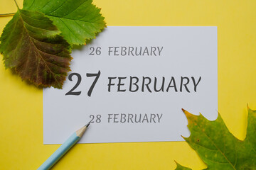 27 february day of month on a white sheet and the dates of the day earlier and later, written in...