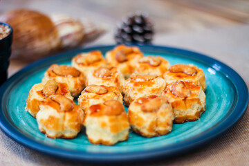 Cashew Nut Cookies placed on a sea-green art-painted plate.