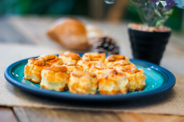 Cashew Nut Cookies placed on a sea-green art-painted plate.