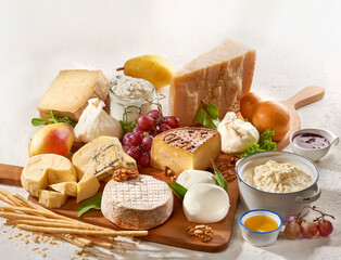 Assorted cheeses on white background