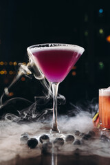 Smoking martini glass with purple drink. Cocktail with blueberries 