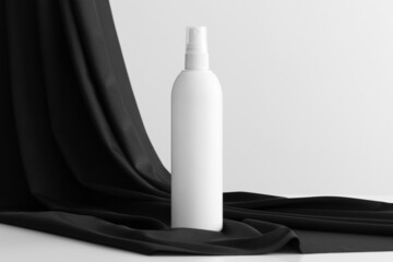 White cosmetic spray bottle mockup on the black textile.
