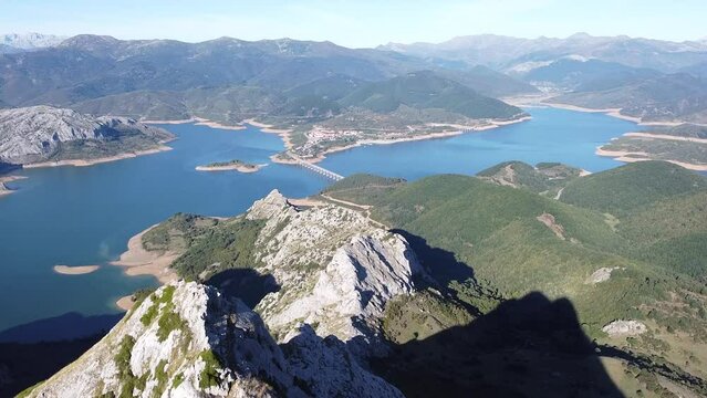 hiker in the top of a mountain summit looking the 
 lake landscape