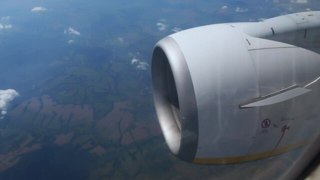 Clouds float across sky at high altitude. Flight above ground. Travel to distant countries. View of the turbine of the aircraft and the off on runway. airplane in flight, view from plane window