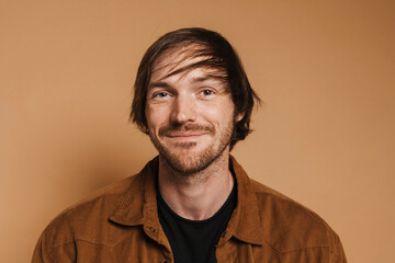 White unshaven man in shirt smiling and looking at camera