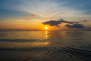 Fototapeta na wymiar Beautiful sunset over the sea water on the island of Koh Phangan, Thailand. Travel and nature concept