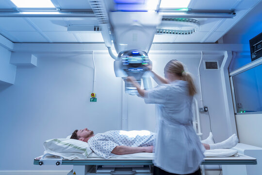 Radiologist Setting Up X-ray Machine In Hospital