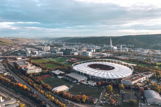 Aerial sunset view of Mercedes-Benz Arena, stadium of football club VFB Stuttgart. Bad Cannstatt, Germany - October 2021