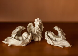 Purchased white figurines of angels close-up on the table
