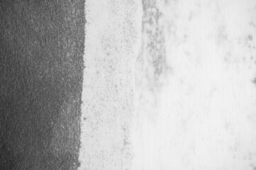 Wall grunge black concrete with light background. Dirty,dust wall concrete blackboard texture and splash white color or abstract background.Dark image.