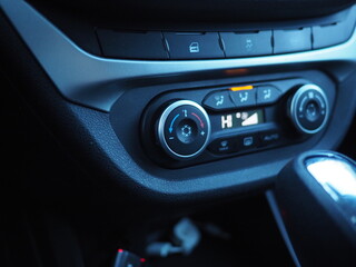 Climate controls in a car close-up. Snowflake icon on the control wheel. Air conditioning, climate control.