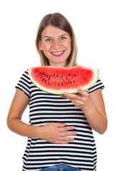 Smiling woman eating watermelon & holding her abdomen