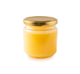Ghee or clarified butter in jar, cooking oil, pure ghee isolated on white background. Clarified butter with copy space for text on white.
