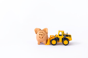 Clay pig with front loader truck toy isolate on white background, pig farming industry concept, handmade clay toy