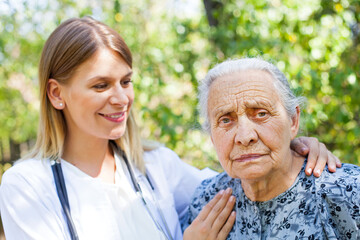 Senior woman with physician in the park