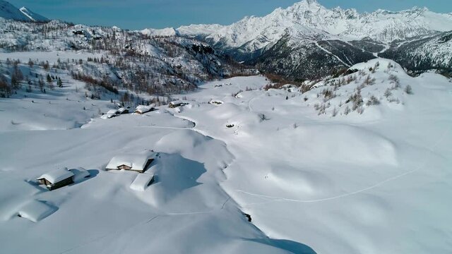 Aerial 4K, snowy landscape in Valmalenco in Campagneda area, Italy