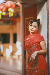 Beautiful Asian Chinese Woman Wearing Cheongsam Traditional Red Dress Fashion Posting Chinese Lunar New Year.