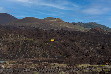 yellow van in a volcanic landscape in Fuencaliente, La Palma, Canary Islands