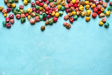 Food background with colorful caramel candy popcorn . Top view with copy space.