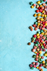 Food background with colorful caramel candy popcorn . Top view with copy space.