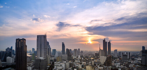 Fototapeta premium Cityscape of modern buildings and urban architecture. Aerial view of Bangkok city at twilight sunset in Thailand.