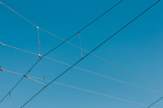 Power line wires against the blue sky.