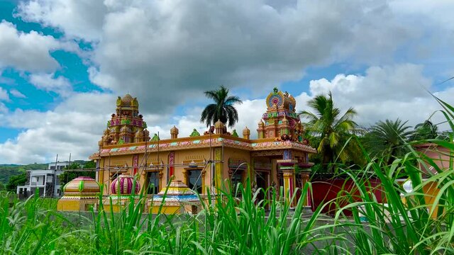 Mauritius, Ganga Talao, 18 January 2022: Indian architecture. View of Indian Temple in Mauritius. Moving clouds in the background