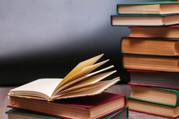 open notepad lies on a pile of books