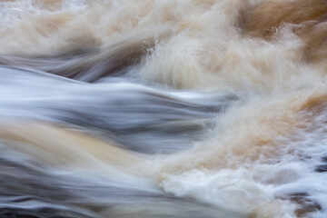 Close up of water flowing over rocks; long exposure image