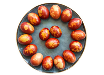 Traditional Easter eggs dyed in onion skins. Bright holiday of Easter. Religious traditions. Easter eggs on straw. Isolated.