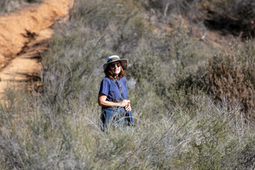 Naklejka premium A Beautiful and Healthy mature Woman on a Hiking Adventure in the California Hills