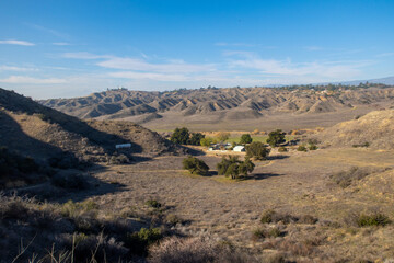 A View of the California Hills Looking at a Valley and a Farmhouse Below