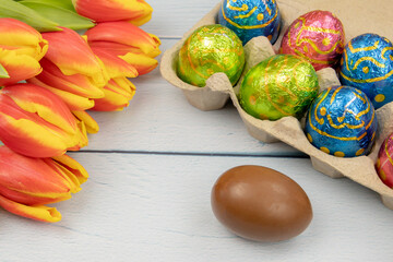 easter eggs and tulips on a wooden background