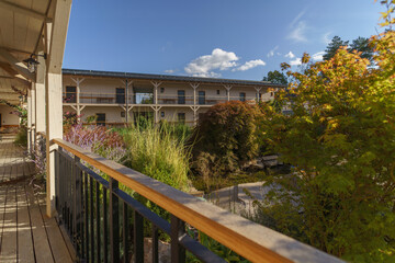 View from terrace of modern hotel with garden and pond