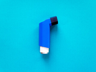 Top view of one inhaler on a bright blue background. World Asthma Day.