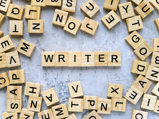 Top view of the word WRITER. Wooden letters are folded into words.