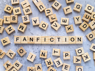 Top view of the word FANFICTION. Wooden letters add up to words.