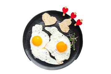 Valentine's day egg breakfast on the table scrambled fried eggs heart shape love holiday decoration date copy space food background