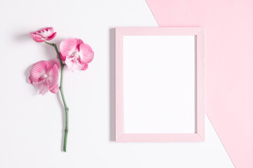 Beautiful flowers composition. Photo frame, pink orchid flower on pastel pink background. Valentines Day, Happy Women's Day. Flat lay, top view, copy space