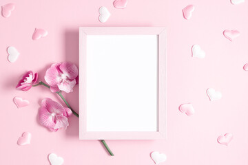 Beautiful flowers composition. Photo frame, pink orchid flower on pastel pink background. Valentines Day, Happy Women's Day. Flat lay, top view, copy space