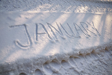 The inscription January on the snow. Winter scenery. Letters on the snow.