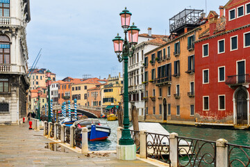 Fototapeta na wymiar Street along the canal in Venice, Italy.